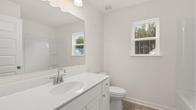 13917 Homer Ln, Covington, GA 30014 - full bathroom featuring baseboards, toilet, a healthy amount of sunlight, and vanity