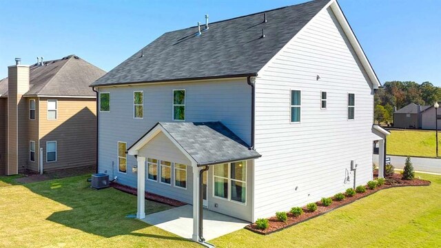 13917 Homer Ln, Covington, GA 30014 - back of house with central AC, a yard, and a patio