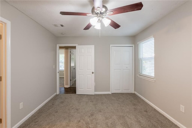 4650 Big Valley Ct, Stone Mountain, GA 30083 - unfurnished bedroom with carpet, baseboards, a closet, and a ceiling fan