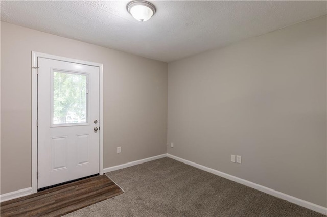 4650 Big Valley Ct, Stone Mountain, GA 30083 - carpeted foyer featuring baseboards and a textured ceiling