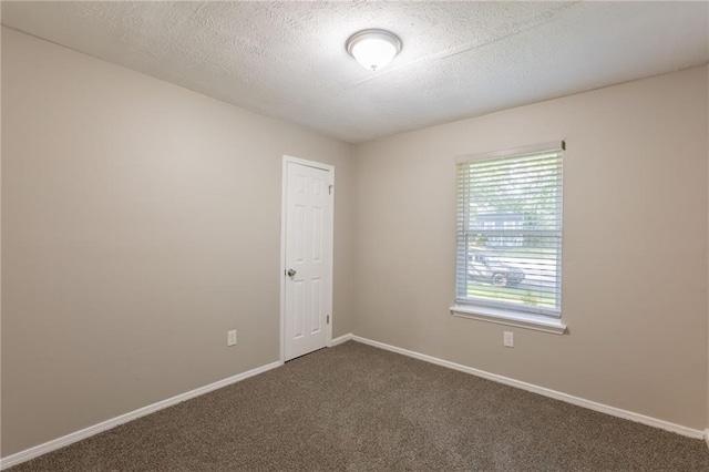 4650 Big Valley Ct, Stone Mountain, GA 30083 - spare room with dark colored carpet, baseboards, and a textured ceiling