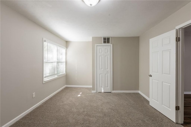 4650 Big Valley Ct, Stone Mountain, GA 30083 - unfurnished bedroom with carpet, baseboards, and a closet