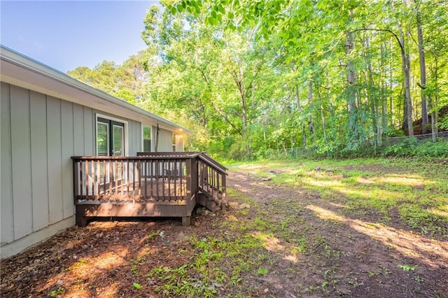 4650 Big Valley Ct, Stone Mountain, GA 30083 - view of yard featuring a deck and a view of trees