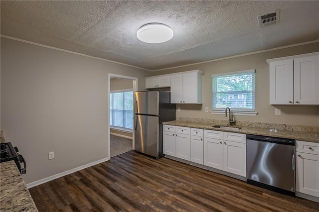 4650 Big Valley Ct, Stone Mountain, GA 30083 - kitchen with appliances with stainless steel finishes, a sink, a textured ceiling, crown molding, and dark wood-style floors