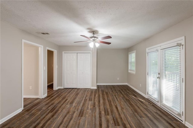 4650 Big Valley Ct, Stone Mountain, GA 30083 - unfurnished bedroom with access to outside, dark wood-type flooring, a textured ceiling, baseboards, and ceiling fan