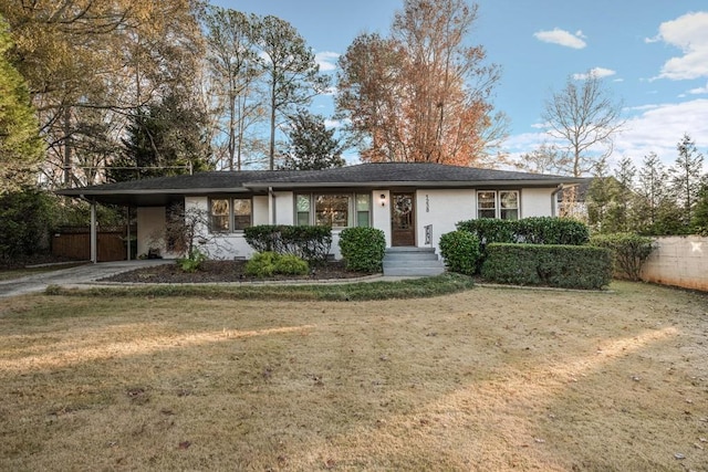 ranch-style house with a front yard and a carport