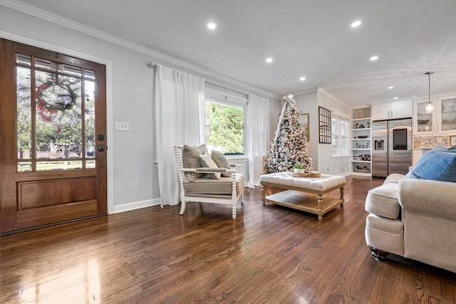 living room with dark hardwood / wood-style flooring, crown molding, and a wealth of natural light