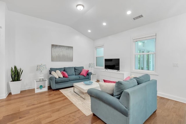 living room with lofted ceiling and hardwood / wood-style floors