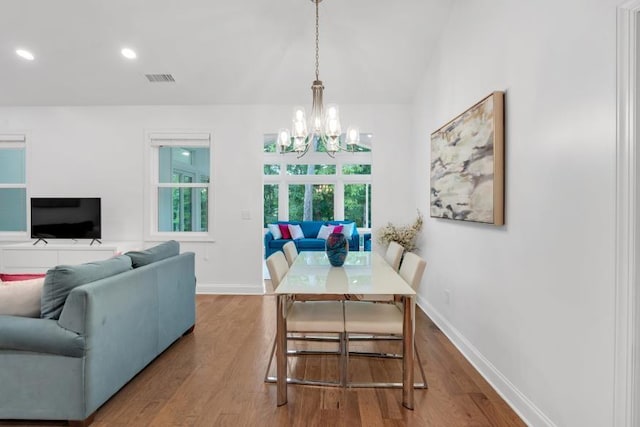 dining room with a notable chandelier and hardwood / wood-style flooring