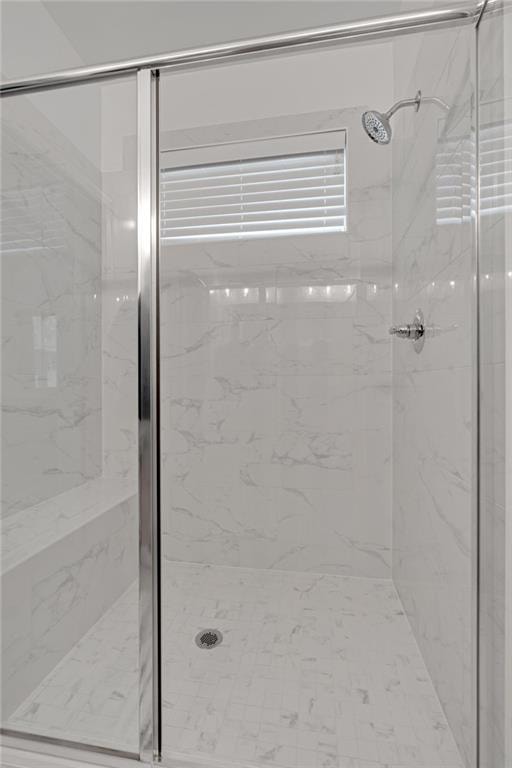 bathroom with a shower with shower door