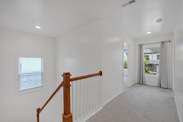 corridor with light colored carpet