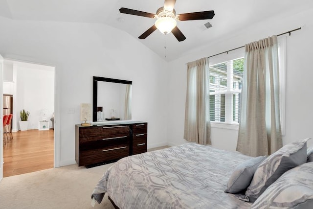 bedroom featuring ceiling fan, lofted ceiling, and light colored carpet