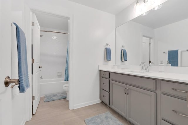 full bathroom featuring vanity, hardwood / wood-style floors, toilet, and shower / tub combo