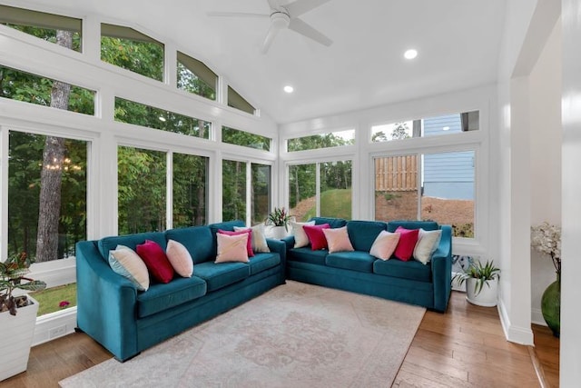 sunroom featuring lofted ceiling, ceiling fan, and plenty of natural light