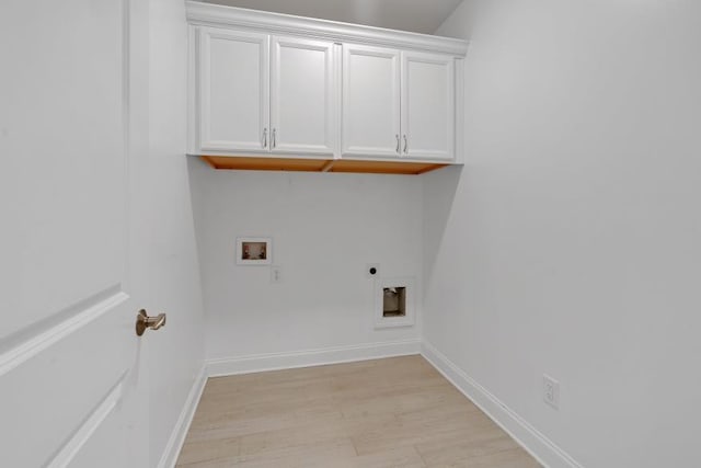 laundry room with cabinets, electric dryer hookup, light wood-type flooring, and washer hookup