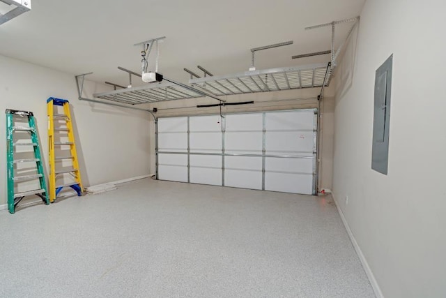 garage with a garage door opener and electric panel