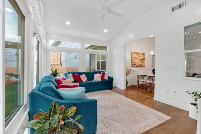 living room featuring wood-type flooring, a healthy amount of sunlight, ceiling fan, and lofted ceiling