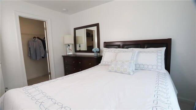 bedroom featuring a walk in closet and a closet