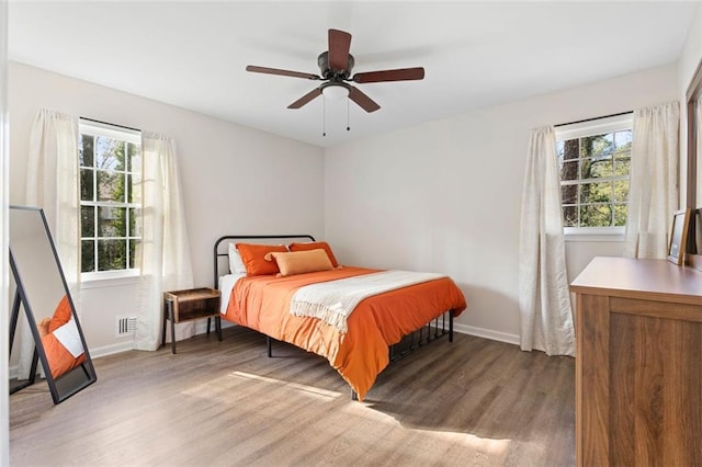 bedroom with hardwood / wood-style floors and ceiling fan