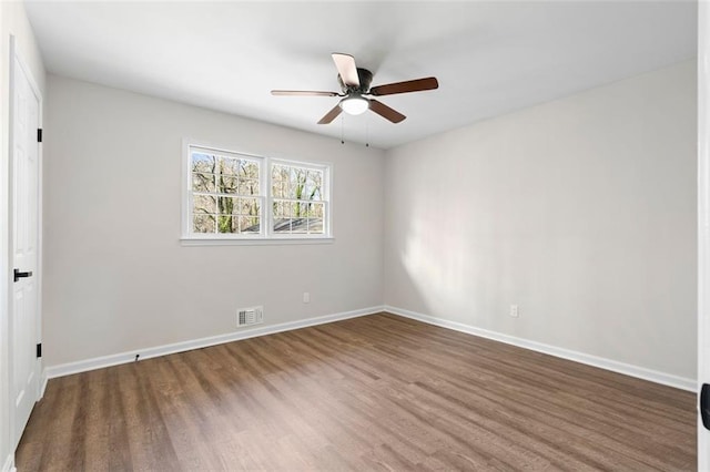 spare room featuring hardwood / wood-style floors and ceiling fan