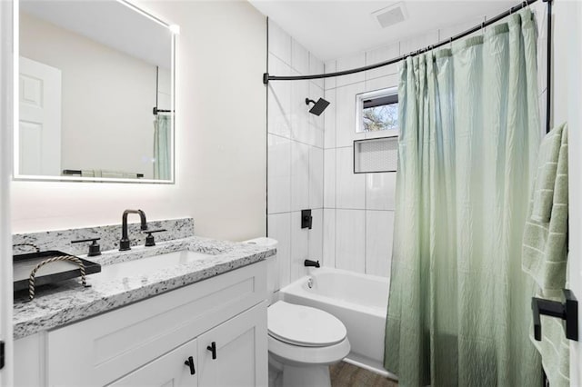 full bathroom with shower / bath combo with shower curtain, vanity, and toilet