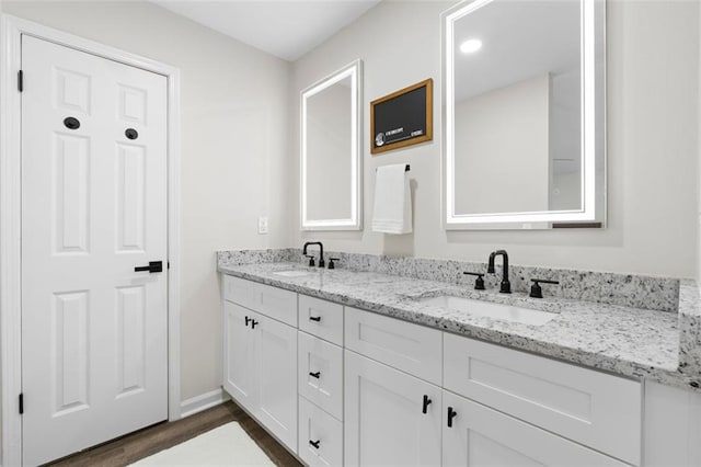 bathroom featuring vanity and hardwood / wood-style flooring