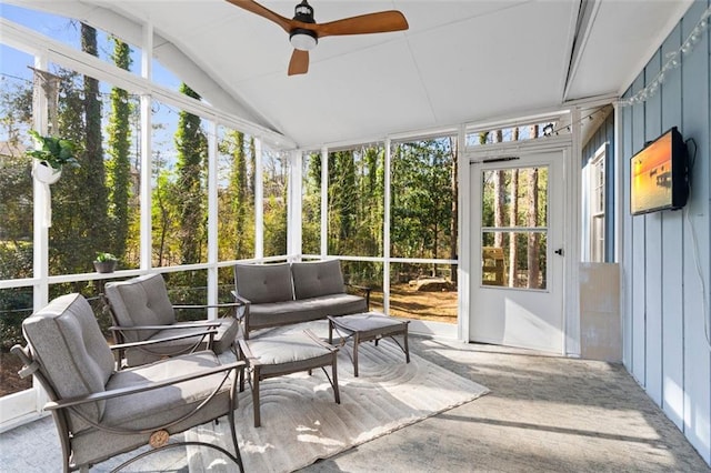 sunroom / solarium with lofted ceiling, ceiling fan, and a healthy amount of sunlight