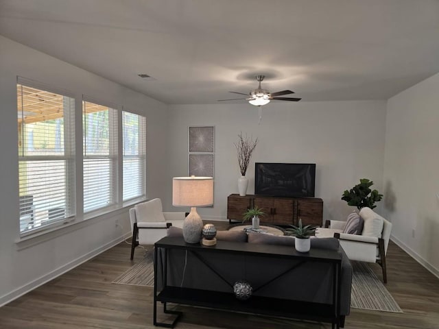 living room featuring hardwood / wood-style floors and ceiling fan