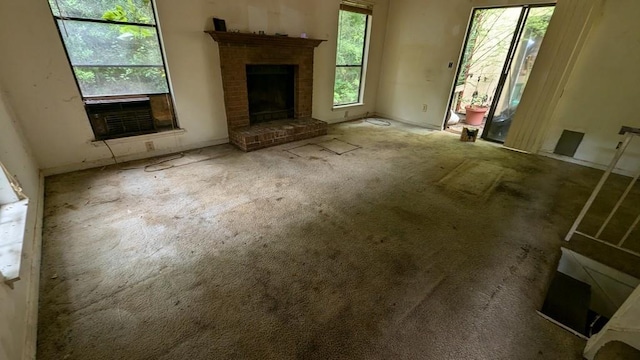 miscellaneous room featuring a fireplace, carpet floors, and plenty of natural light