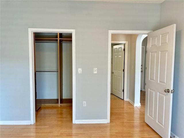 unfurnished bedroom with light hardwood / wood-style floors and a closet