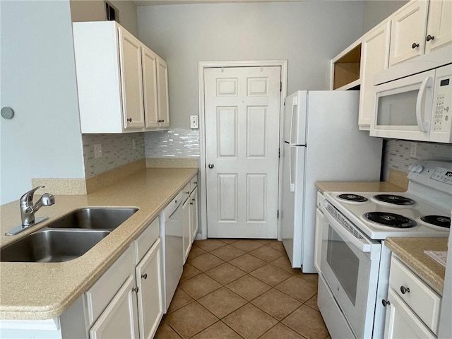 kitchen featuring white appliances, sink, and white cabinets