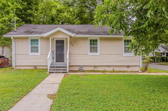 2245 Dauphine St, Atlanta, GA 30344 - view of front facade with crawl space, a front lawn, board and batten siding, and roof with shingles