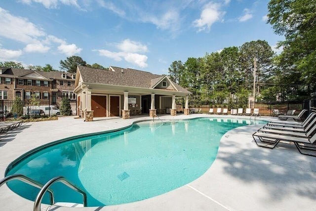 pool with fence and a patio