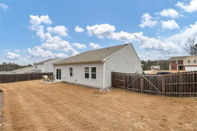 rear view of house featuring a patio area and a yard