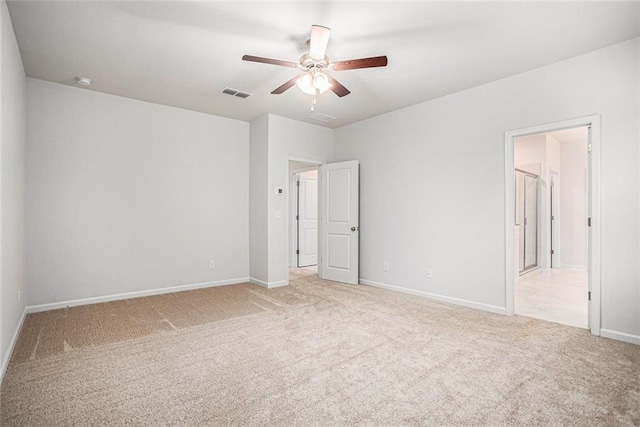 carpeted spare room with ceiling fan