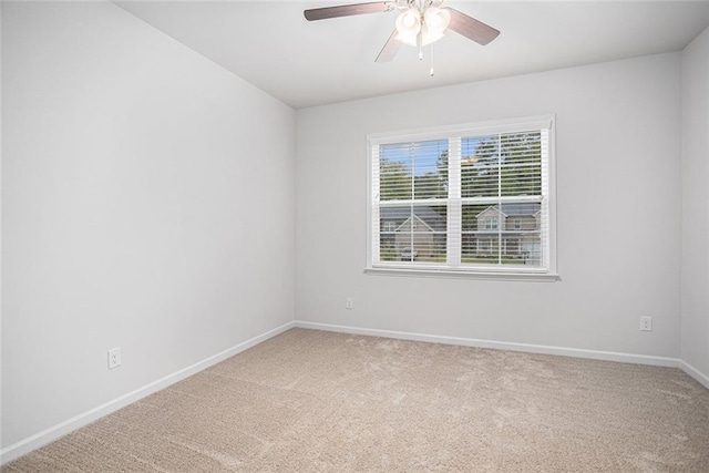 empty room with ceiling fan and carpet flooring