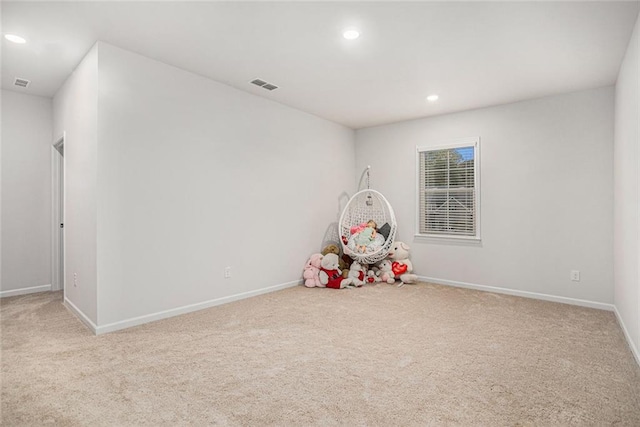 recreation room featuring light carpet