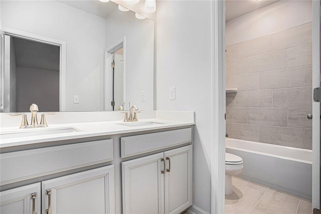 full bathroom with toilet, tiled shower / bath combo, vanity, and tile patterned flooring