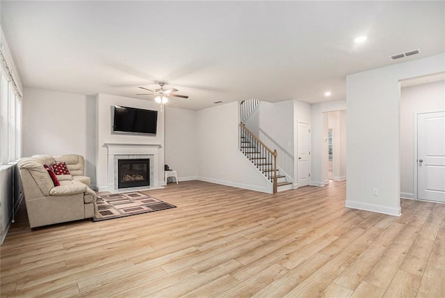 living room featuring ceiling fan and light wood-type flooring