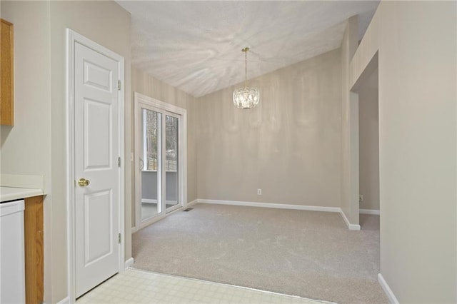 unfurnished dining area with light carpet and a notable chandelier