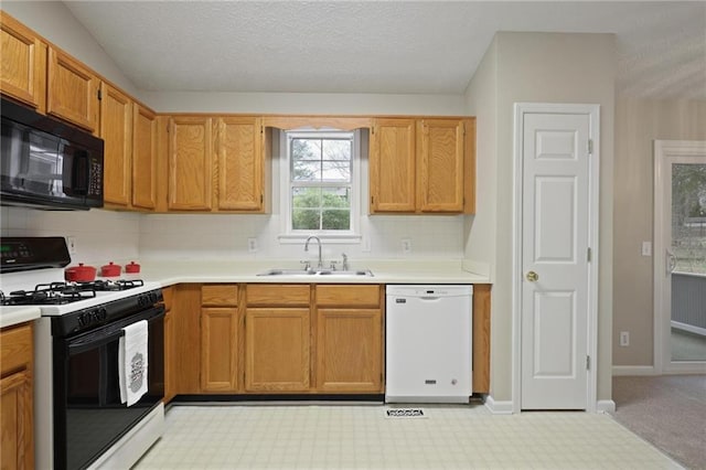 kitchen with sink, decorative backsplash, range with gas cooktop, and dishwasher