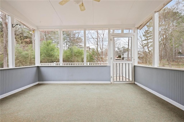 unfurnished sunroom featuring ceiling fan