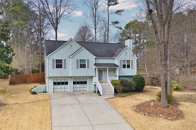 raised ranch featuring a garage and covered porch