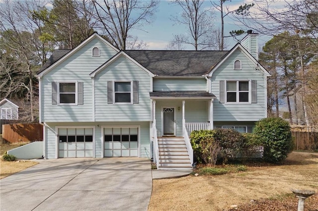 bi-level home featuring a garage and a porch