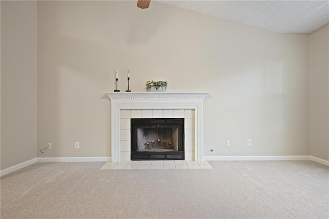 unfurnished living room featuring vaulted ceiling, light carpet, and a fireplace