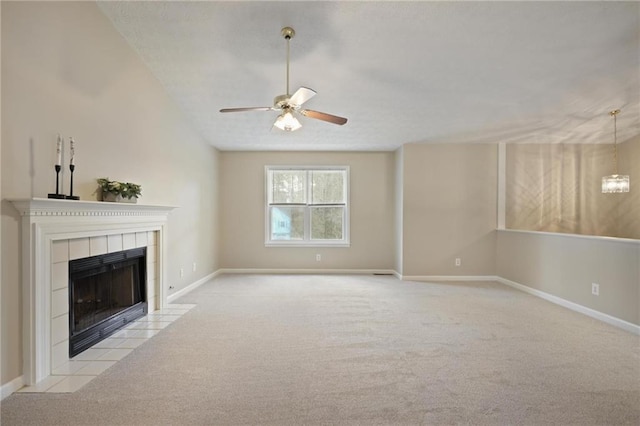 unfurnished living room featuring ceiling fan, light colored carpet, and a fireplace