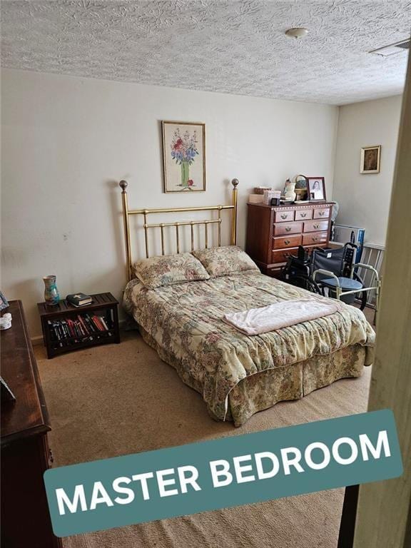 carpeted bedroom with a textured ceiling