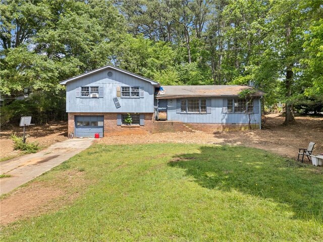 302 Cardinal Dr, Woodstock, GA 30188 - tri-level home featuring concrete driveway, brick siding, an attached garage, and a front lawn