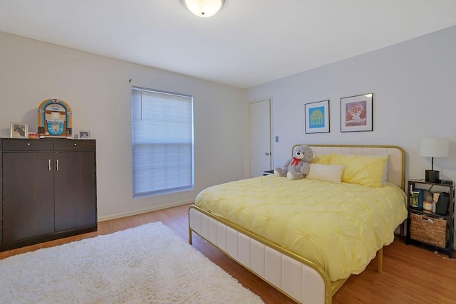 bedroom with hardwood / wood-style flooring