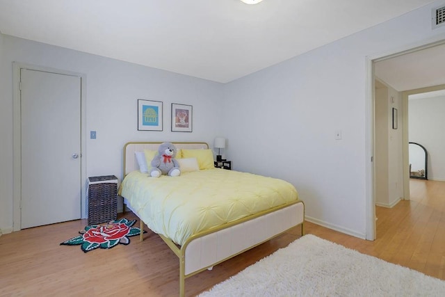 bedroom with hardwood / wood-style floors